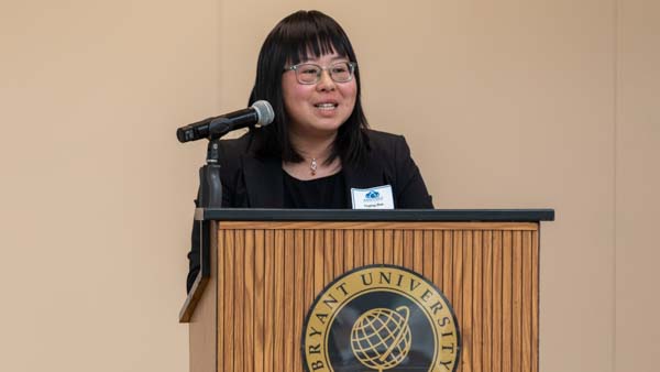 Tingting Zhao speaks at Bryant podium.